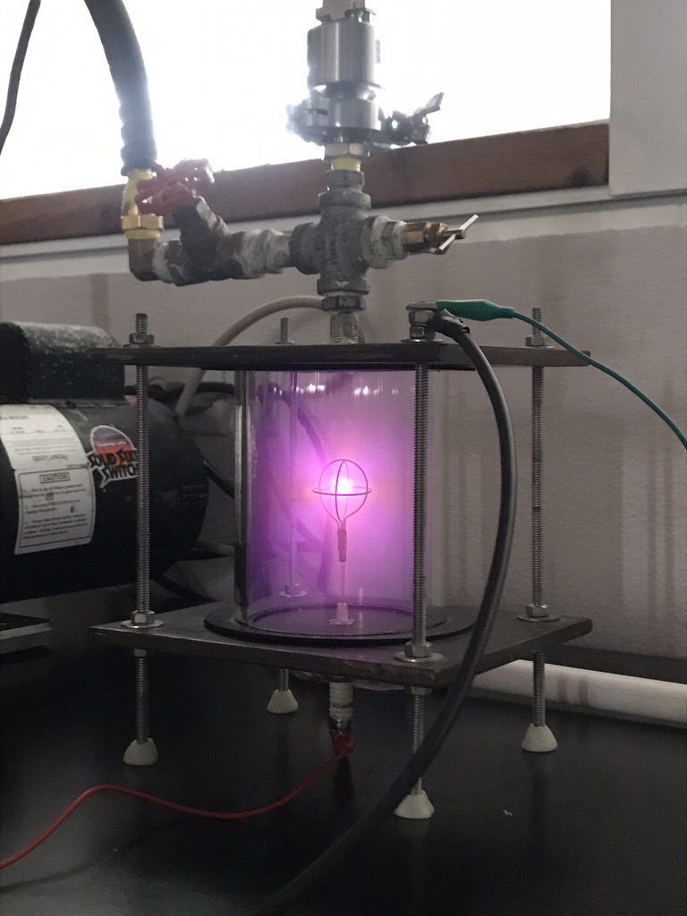 Pink plasma glow in the fusor chamber