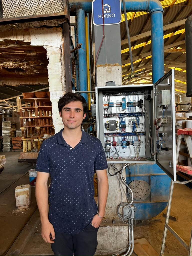 Pablo standing beside the Beckhoff control cabinet installed on the industrial gas kiln